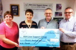 Harold Medlow presents a cheque to Founder, Kay Duffy. Also in the photo are his wife and son.